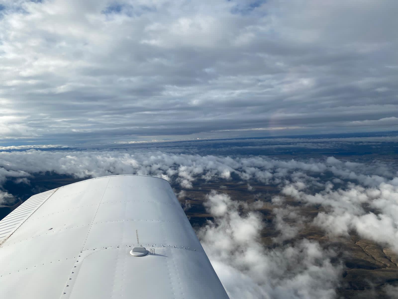 Glider in flight over mountains